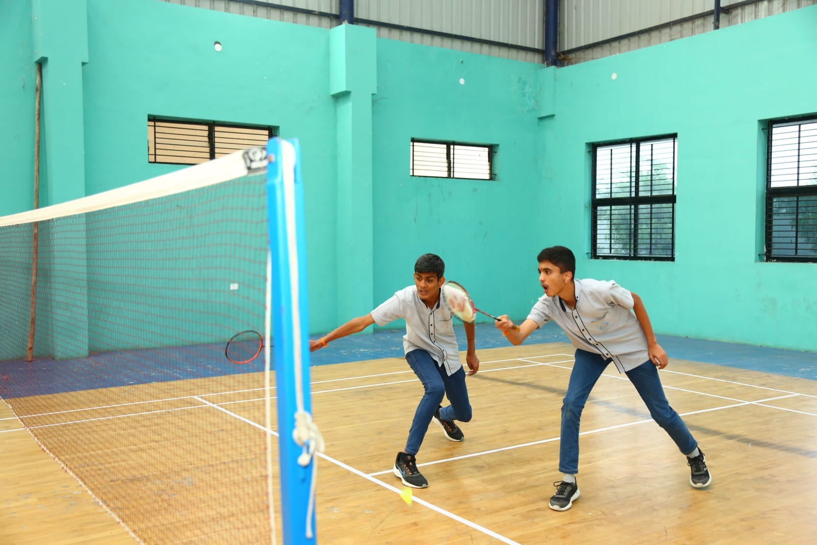 Students playing badminton rally at Sri Sharada International School